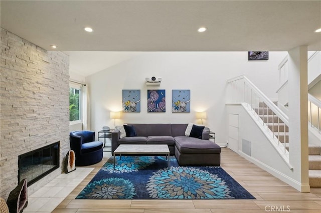 306 San Nicholas Ct, Laguna Beach, CA 92651 - living room with light wood-type flooring, stairway, lofted ceiling, recessed lighting, and a stone fireplace