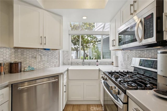 306 San Nicholas Ct, Laguna Beach, CA 92651 - kitchen with stainless steel appliances, light countertops, white cabinetry, and backsplash
