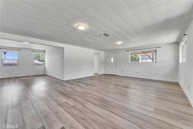 6910 Carnelian St, Rancho Cucamonga, CA 91701 - empty room with light wood-style floors and healthy amount of natural light