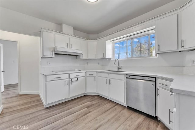 6910 Carnelian St, Rancho Cucamonga, CA 91701 - kitchen featuring stainless steel dishwasher, under cabinet range hood, light countertops, light wood-style flooring, and white cabinetry