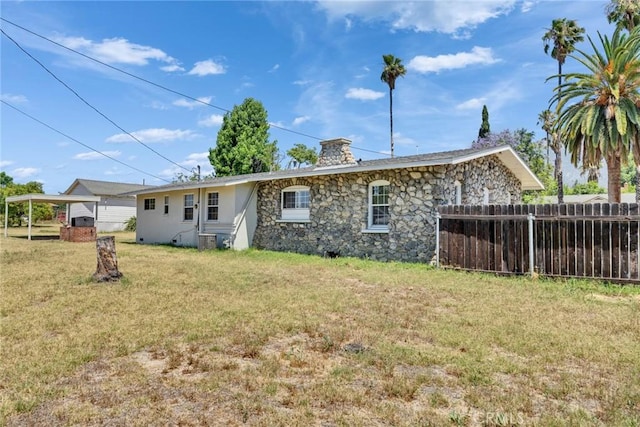 6910 Carnelian St, Rancho Cucamonga, CA 91701 - rear view of property featuring stone siding and a chimney