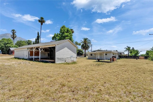 6910 Carnelian St, Rancho Cucamonga, CA 91701 - view of grassy yard with a mountain view, an outbuilding, and a pole building