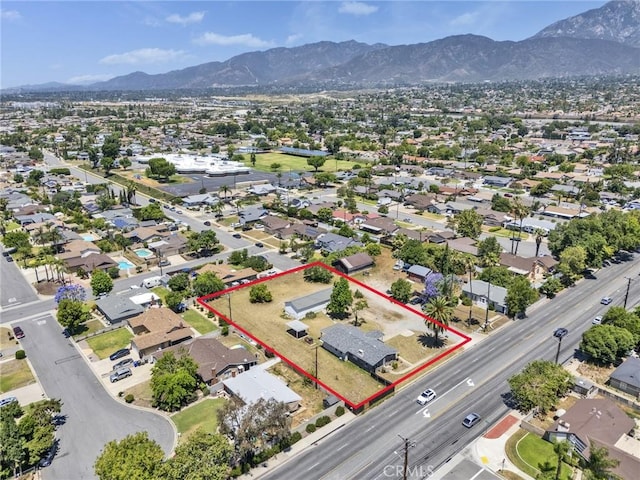 6910 Carnelian St, Rancho Cucamonga, CA 91701 - aerial view of residential area featuring a mountainous background and property boundaries highlighted