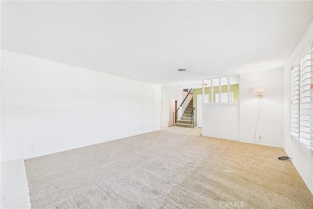 10469 Gregory Cir, Cypress, CA 90630 - spare room with carpet, stairs, and a textured ceiling