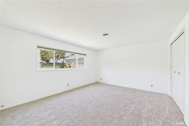 10469 Gregory Cir, Cypress, CA 90630 - carpeted empty room with a textured ceiling