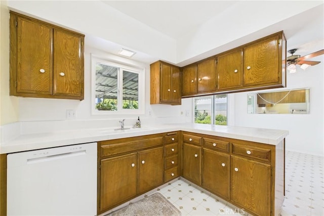 10469 Gregory Cir, Cypress, CA 90630 - kitchen featuring dishwasher, light floors, a peninsula, brown cabinets, and light countertops