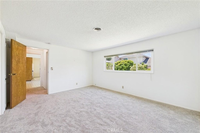 10469 Gregory Cir, Cypress, CA 90630 - spare room with carpet and a textured ceiling