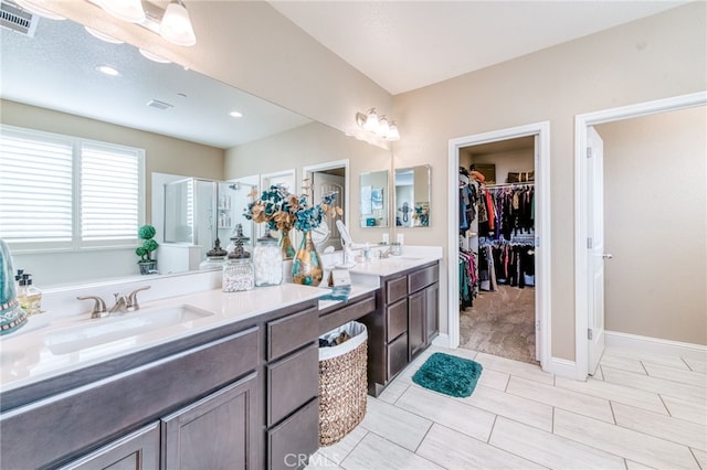 14655 Spanish Bay Way, Chowchilla, CA 93610 - full bathroom with double vanity, a walk in closet, a shower, and recessed lighting