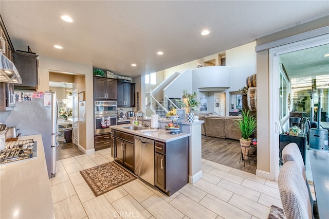 14655 Spanish Bay Way, Chowchilla, CA 93610 - kitchen featuring stainless steel appliances, open floor plan, dark brown cabinetry, light countertops, and recessed lighting