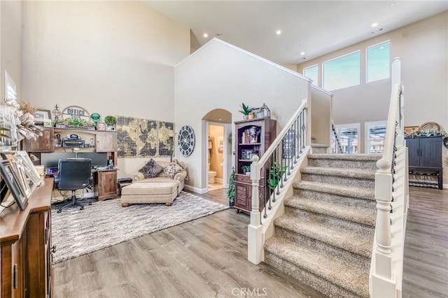 14655 Spanish Bay Way, Chowchilla, CA 93610 - staircase featuring a towering ceiling, wood finished floors, recessed lighting, and arched walkways