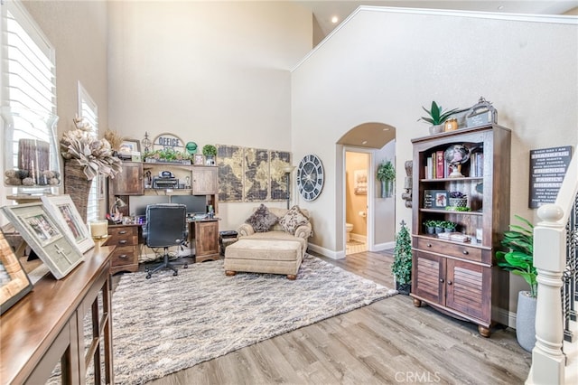 14655 Spanish Bay Way, Chowchilla, CA 93610 - home office featuring arched walkways, a towering ceiling, and light wood finished floors