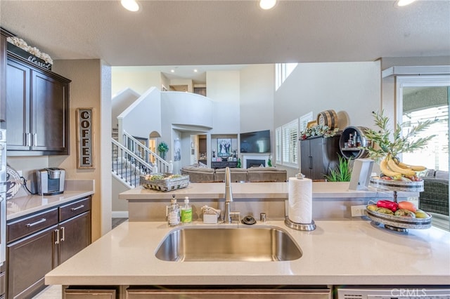 14655 Spanish Bay Way, Chowchilla, CA 93610 - kitchen with dark brown cabinets, light countertops, open floor plan, a textured ceiling, and dishwasher