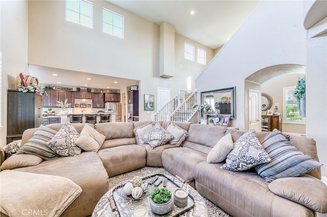 14655 Spanish Bay Way, Chowchilla, CA 93610 - living room with arched walkways, a towering ceiling, healthy amount of natural light, stairway, and recessed lighting