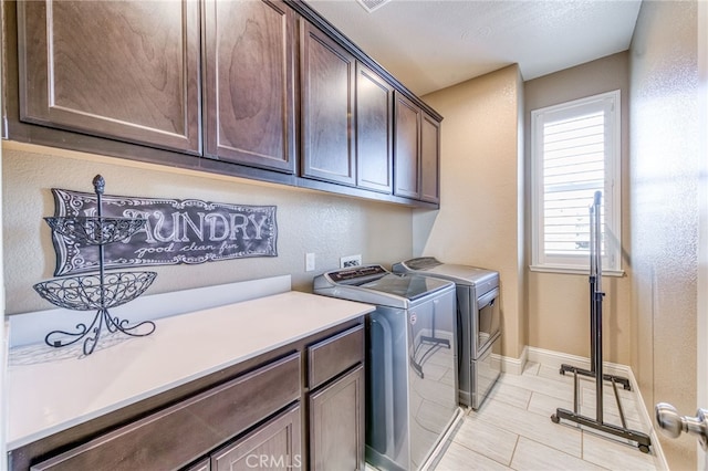 14655 Spanish Bay Way, Chowchilla, CA 93610 - laundry room featuring cabinet space, washer and dryer, light tile patterned floors, and a textured wall