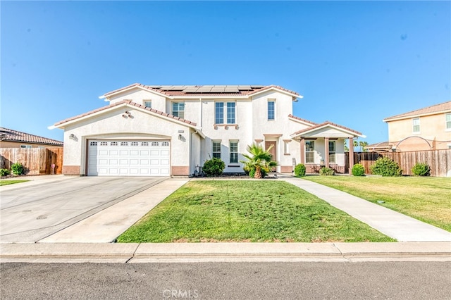 14655 Spanish Bay Way, Chowchilla, CA 93610 - mediterranean / spanish house featuring a tiled roof, roof mounted solar panels, stucco siding, and an attached garage