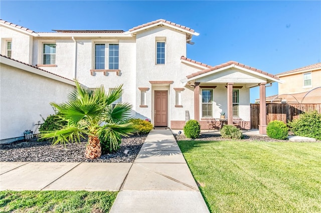 14655 Spanish Bay Way, Chowchilla, CA 93610 - view of front of house with a tiled roof, stucco siding, covered porch, and roof mounted solar panels