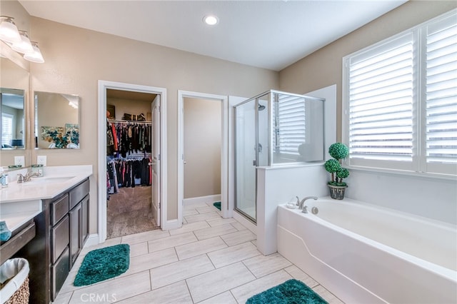 14655 Spanish Bay Way, Chowchilla, CA 93610 - bathroom featuring a stall shower, vanity, a garden tub, a spacious closet, and tile patterned floors