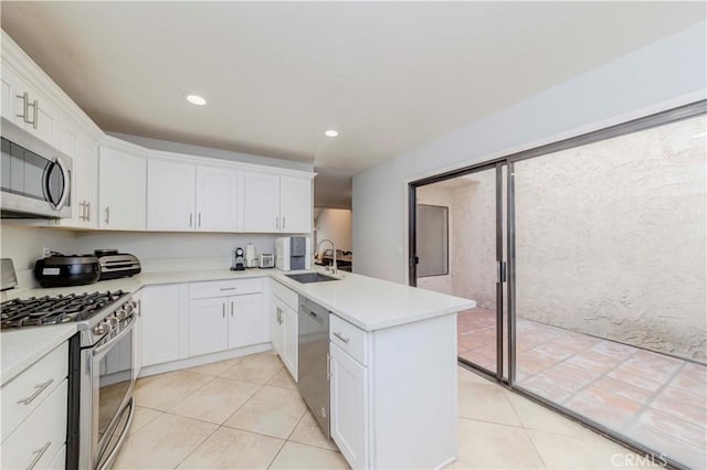 9724 Walker Ct Unit 18, Cypress, CA 90630 - kitchen with stainless steel appliances, a peninsula, white cabinetry, light countertops, and recessed lighting