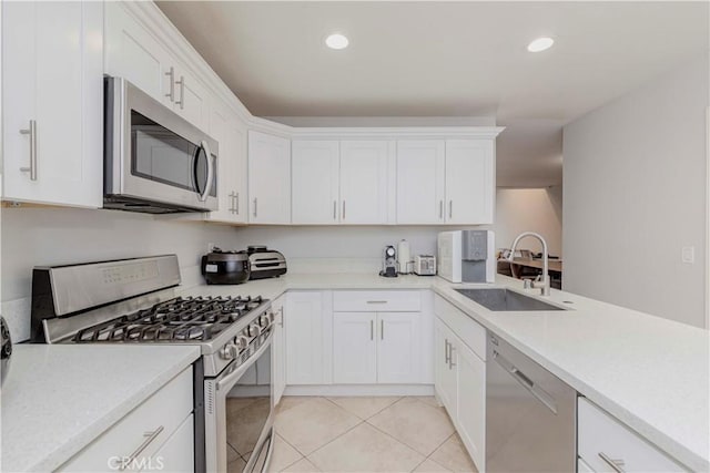 9724 Walker Ct Unit 18, Cypress, CA 90630 - kitchen with stainless steel appliances, white cabinets, light countertops, light tile patterned floors, and recessed lighting