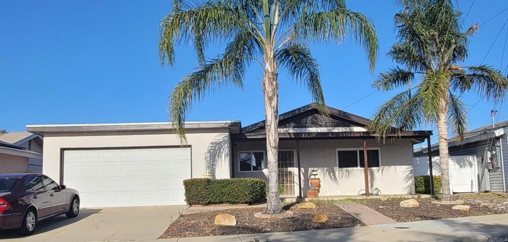 1477 Signal Ave, San Diego, CA 92154 - ranch-style house with stucco siding, an attached garage, and concrete driveway