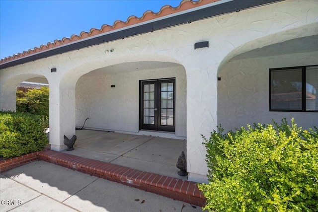 1140 W Lancaster Blvd, Lancaster, CA 93534 - view of exterior entry featuring french doors, stucco siding, and a patio area