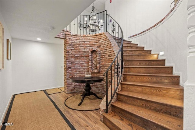 1140 W Lancaster Blvd, Lancaster, CA 93534 - stairs featuring wood finished floors, a chandelier, and recessed lighting