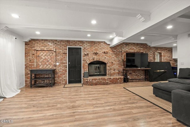 1140 W Lancaster Blvd, Lancaster, CA 93534 - living room with a brick fireplace, wood finished floors, beam ceiling, recessed lighting, and brick wall