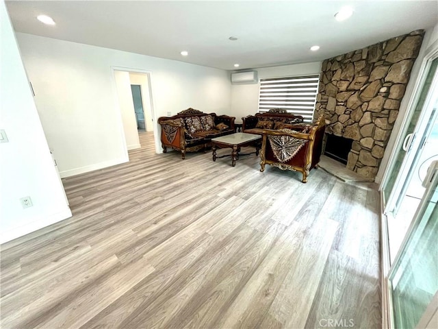 125 Campanita Ct, Monterey Park, CA 91754 - living room with an AC wall unit, wood finished floors, a stone fireplace, and recessed lighting
