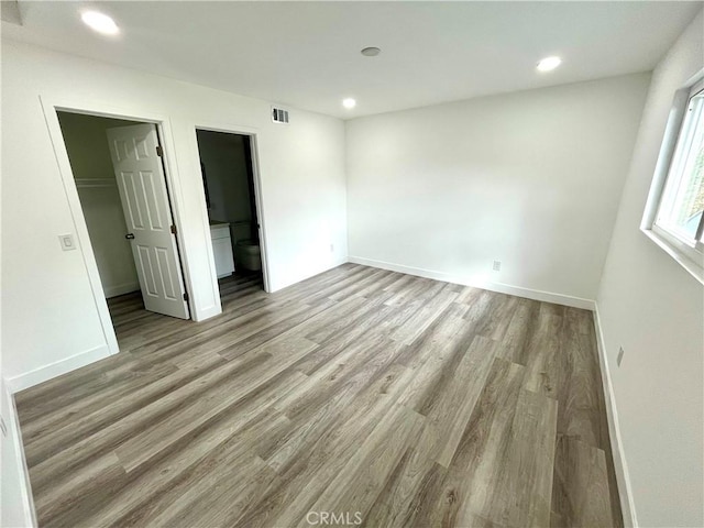 125 Campanita Ct, Monterey Park, CA 91754 - unfurnished bedroom with wood finished floors, a walk in closet, and recessed lighting