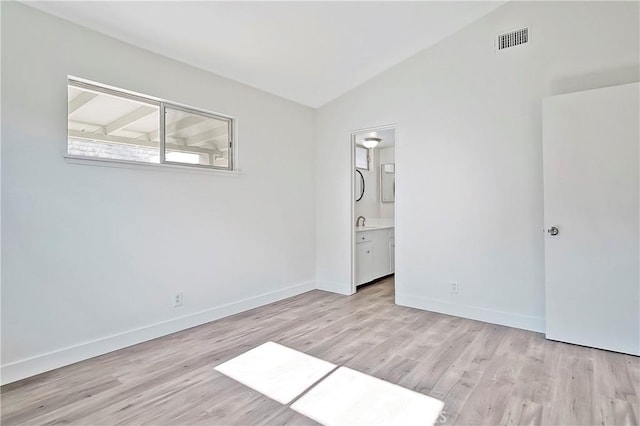 6470 Flamingo Dr, Buena Park, CA 90620 - unfurnished bedroom featuring lofted ceiling, light wood-type flooring, and connected bathroom