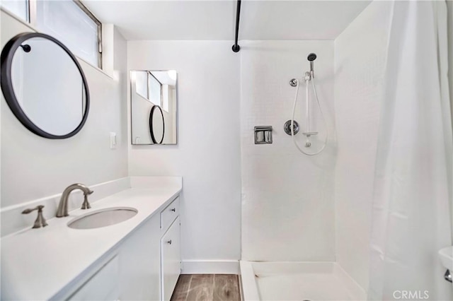 6470 Flamingo Dr, Buena Park, CA 90620 - bathroom featuring a shower with shower curtain, vanity, and wood finished floors