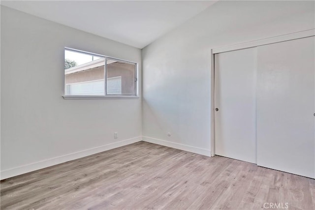 6470 Flamingo Dr, Buena Park, CA 90620 - unfurnished bedroom with wood finished floors, a closet, and vaulted ceiling