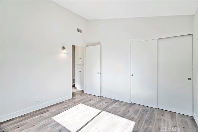6470 Flamingo Dr, Buena Park, CA 90620 - unfurnished bedroom featuring light wood finished floors, a closet, and high vaulted ceiling
