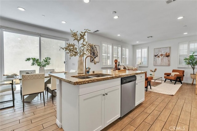 10578 Wells Dr, Rancho Cucamonga, CA 91730 - kitchen with dishwasher, plenty of natural light, light wood-style floors, white cabinetry, and recessed lighting