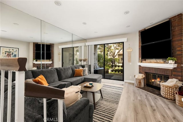 314 Molokai Dr, Placentia, CA 92870 - living room featuring wood finished floors, a brick fireplace, and recessed lighting
