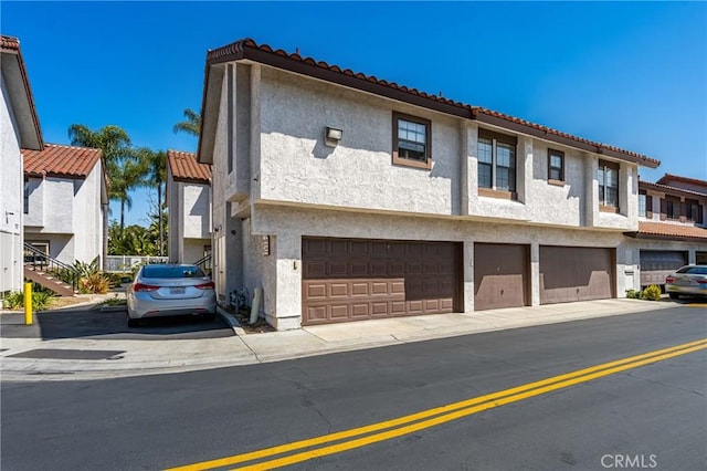 314 Molokai Dr, Placentia, CA 92870 - view of front of property featuring stucco siding, an attached garage, a tiled roof, and driveway