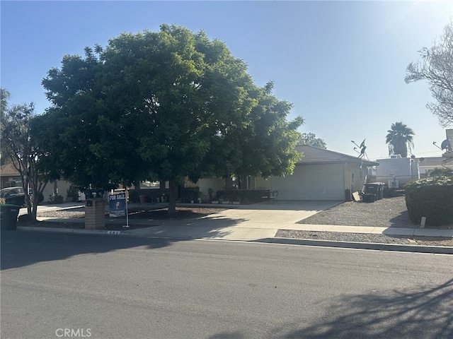 621 Brian St, Hemet, CA 92544 - view of property hidden behind natural elements featuring an attached garage and driveway