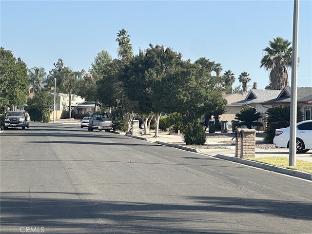 621 Brian St, Hemet, CA 92544 - view of asphalt road featuring curbs, sidewalks, and street lighting