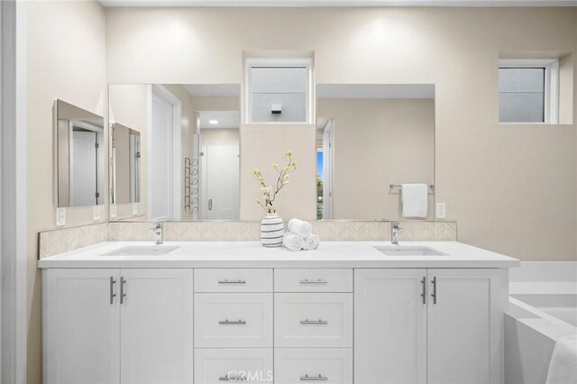 160 Mirth, Irvine, CA 92618 - full bath featuring double vanity, backsplash, and a garden tub