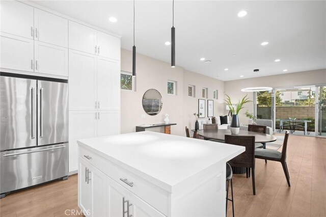 160 Mirth, Irvine, CA 92618 - kitchen with high end refrigerator, a center island, light wood finished floors, recessed lighting, and white cabinetry