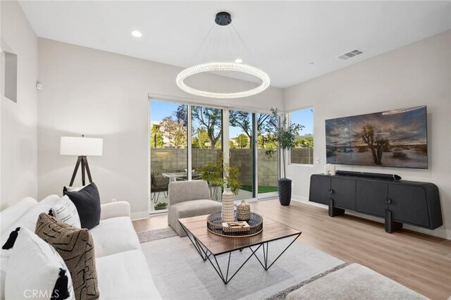 160 Mirth, Irvine, CA 92618 - living room with wood finished floors, recessed lighting, and a chandelier