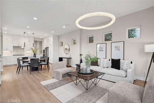 160 Mirth, Irvine, CA 92618 - living area featuring light wood finished floors, recessed lighting, a chandelier, and a high ceiling