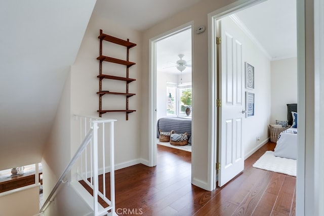 25001 Mackenzie St, Laguna Hills, CA 92653 - hall featuring an upstairs landing, dark wood finished floors, and ornamental molding