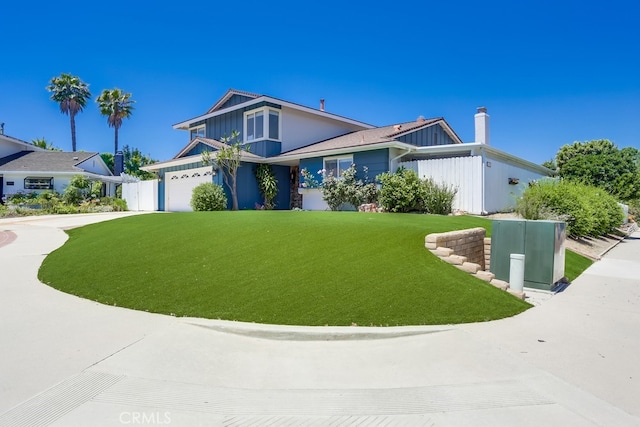 25001 Mackenzie St, Laguna Hills, CA 92653 - view of front facade with a front yard, driveway, an attached garage, and a chimney