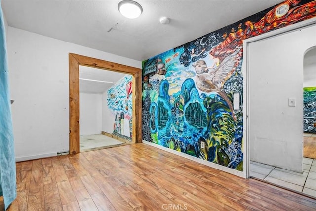 6685 Navajoa Ave, Atascadero, CA 93422 - empty room featuring arched walkways, wood finished floors, and a smoke detector