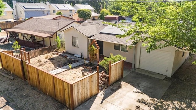 6685 Navajoa Ave, Atascadero, CA 93422 - view of front of house with concrete driveway, stucco siding, a garage, roof with shingles, and solar panels
