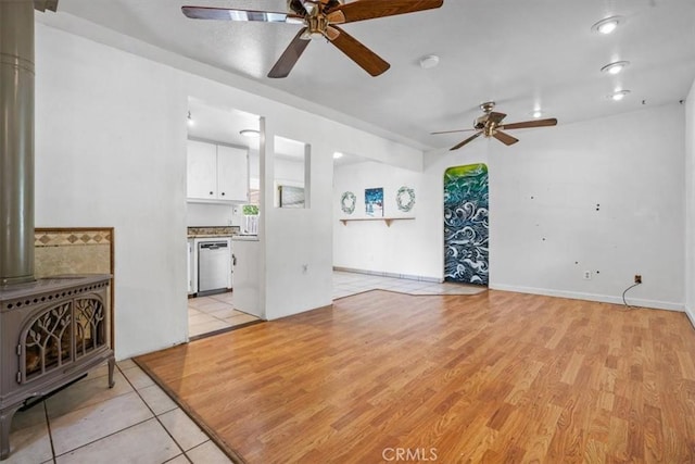 6685 Navajoa Ave, Atascadero, CA 93422 - unfurnished living room featuring a wood stove, ceiling fan, and light wood finished floors