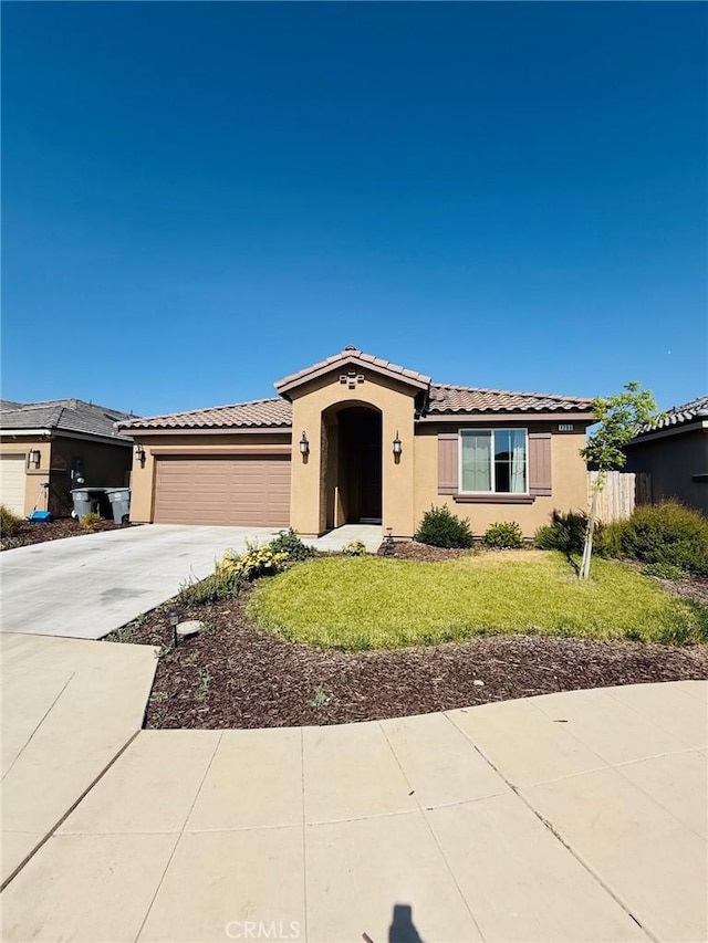 1206 Bristlecone Dr, Madera, CA 93638 - view of front of home featuring a tile roof, stucco siding, driveway, and an attached garage