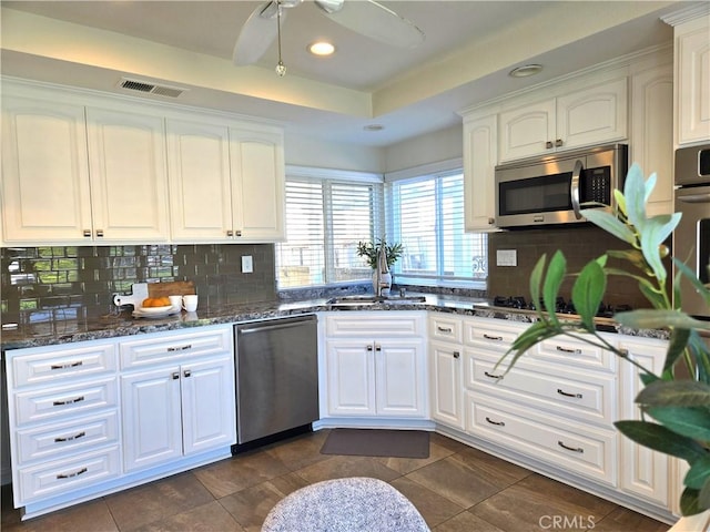 868 Ethelinda Way, Brea, CA 92821 - kitchen with appliances with stainless steel finishes, white cabinetry, tasteful backsplash, dark stone countertops, and recessed lighting