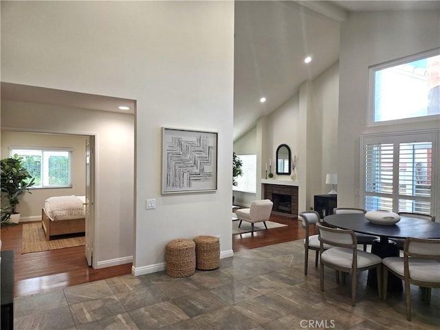 868 Ethelinda Way, Brea, CA 92821 - dining room featuring high vaulted ceiling, a brick fireplace, beamed ceiling, recessed lighting, and dark wood-style flooring